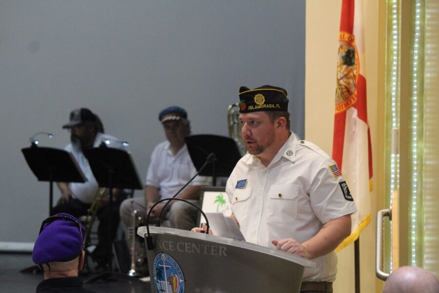 a man standing at a podium in front of a group of people