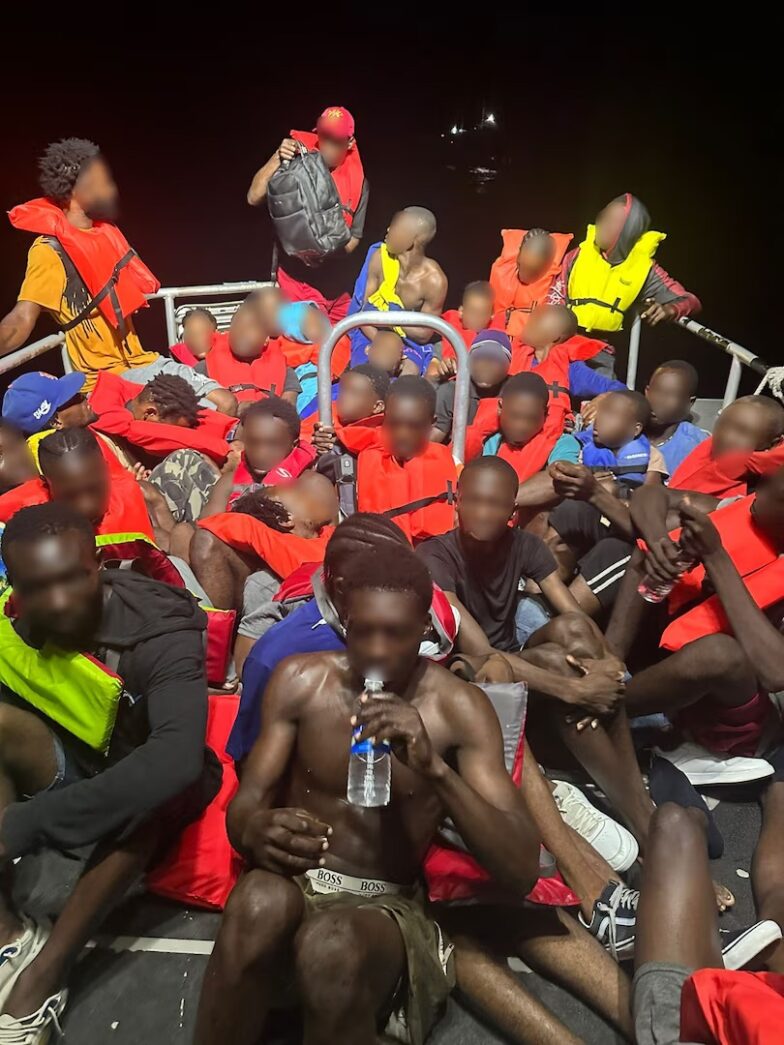 a group of men sitting on top of a boat