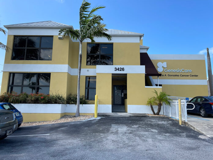 a yellow building with cars parked in front of it