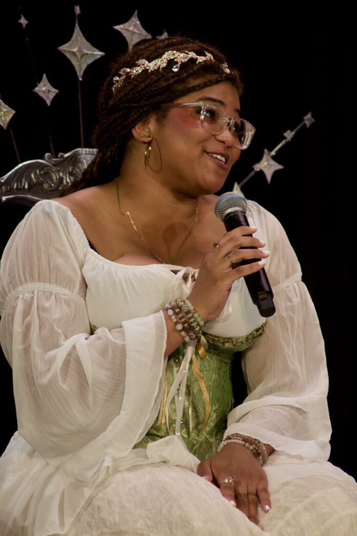 a woman in a white dress holding a microphone