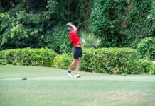 a man swinging a golf club on a golf course