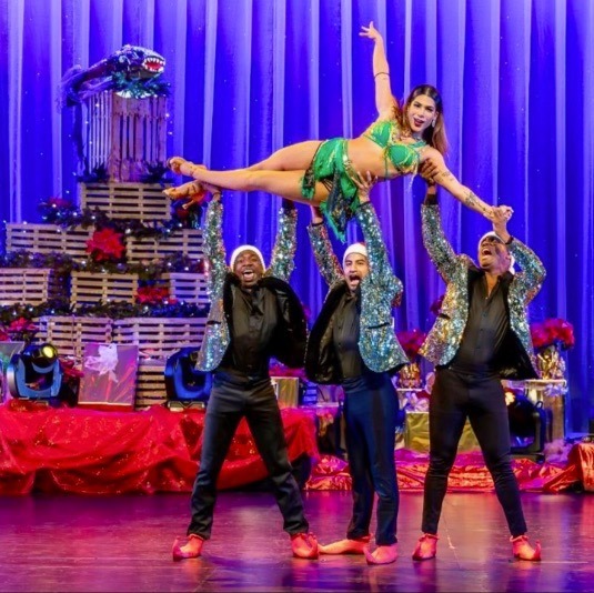 a group of people standing on top of a stage