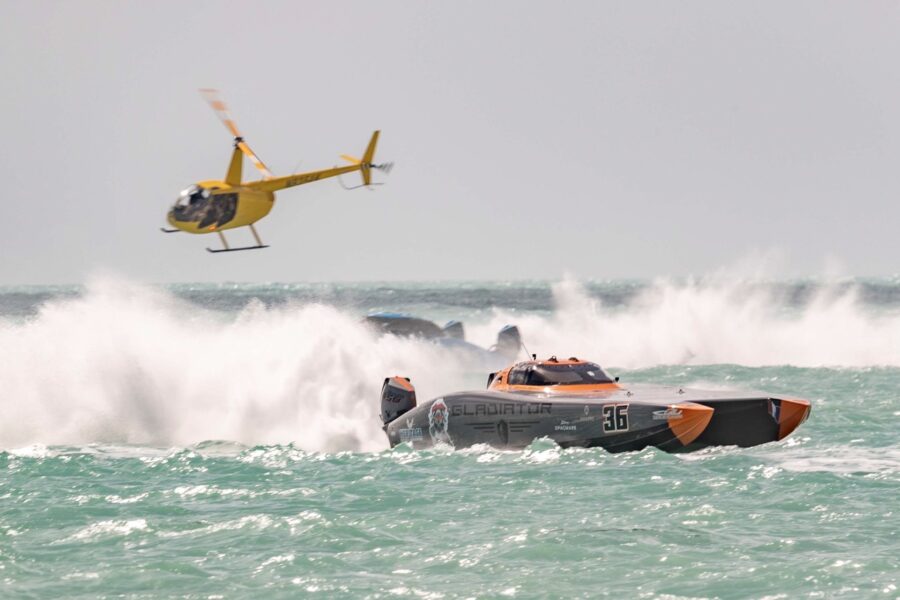 a helicopter flying over a boat in the ocean