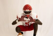 a man in a football uniform holding a football