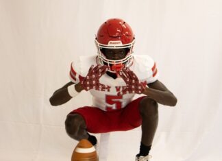 a man in a football uniform holding a football