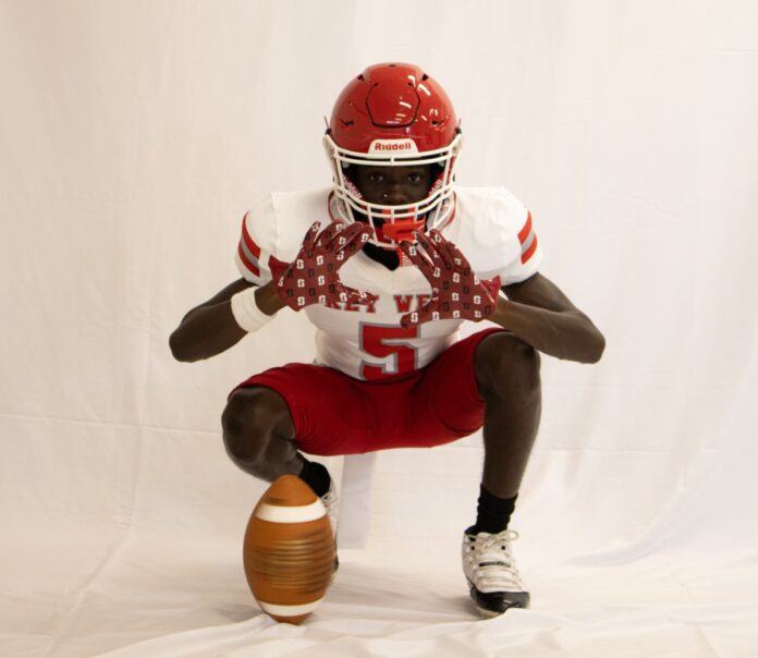 a man in a football uniform holding a football