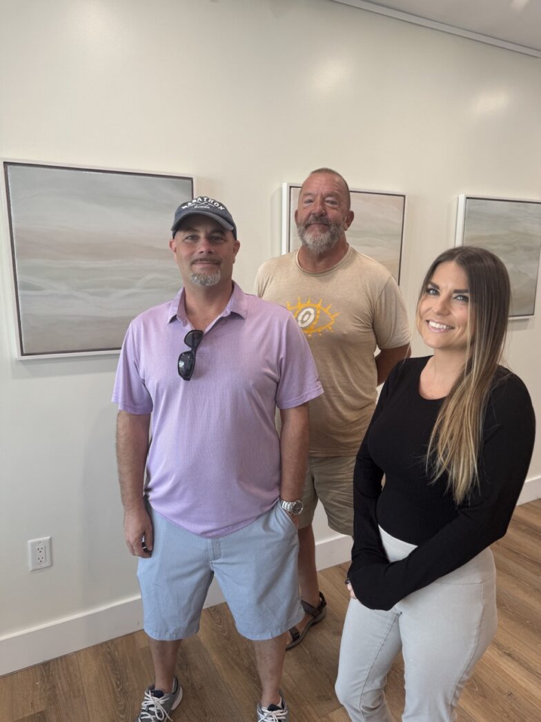 a group of people standing next to each other in a room