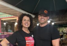 a man and a woman standing under an umbrella