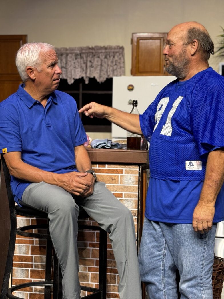 two men sitting at a bar talking to each other