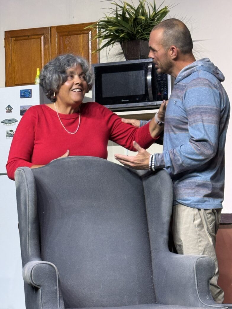 a man standing next to a woman in a kitchen