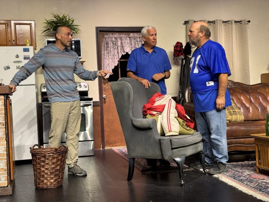 a group of men standing around a living room