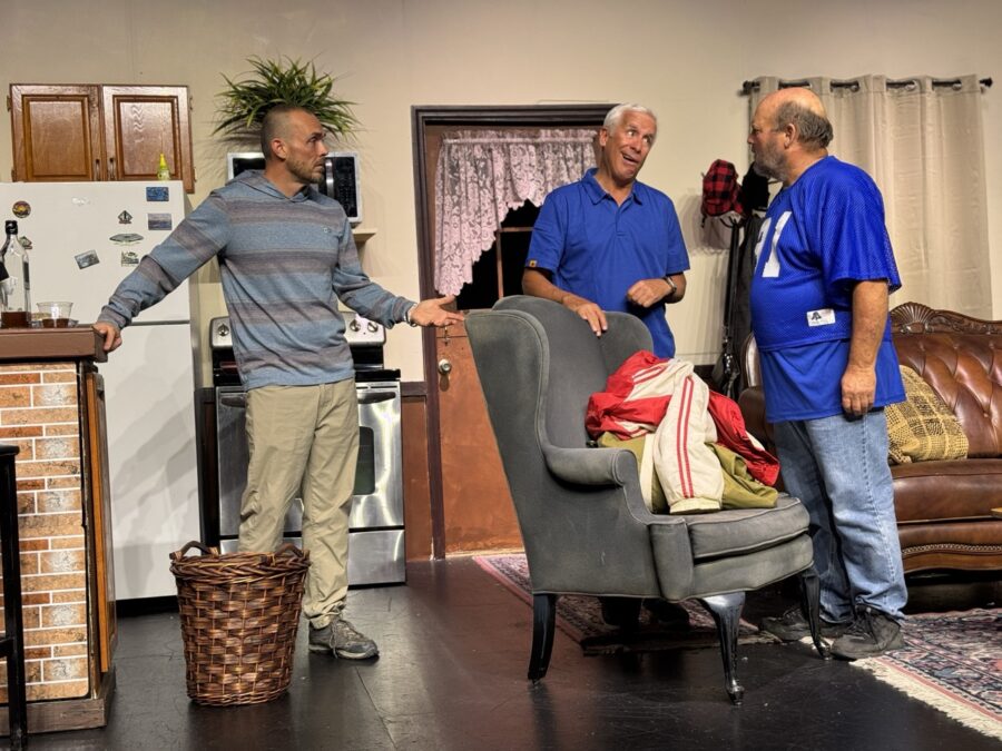 a group of men standing around a living room