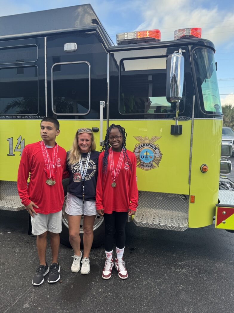 a group of people standing in front of a fire truck