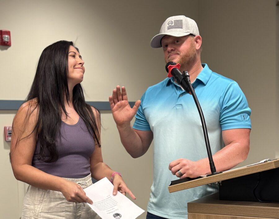 a man standing next to a woman at a podium