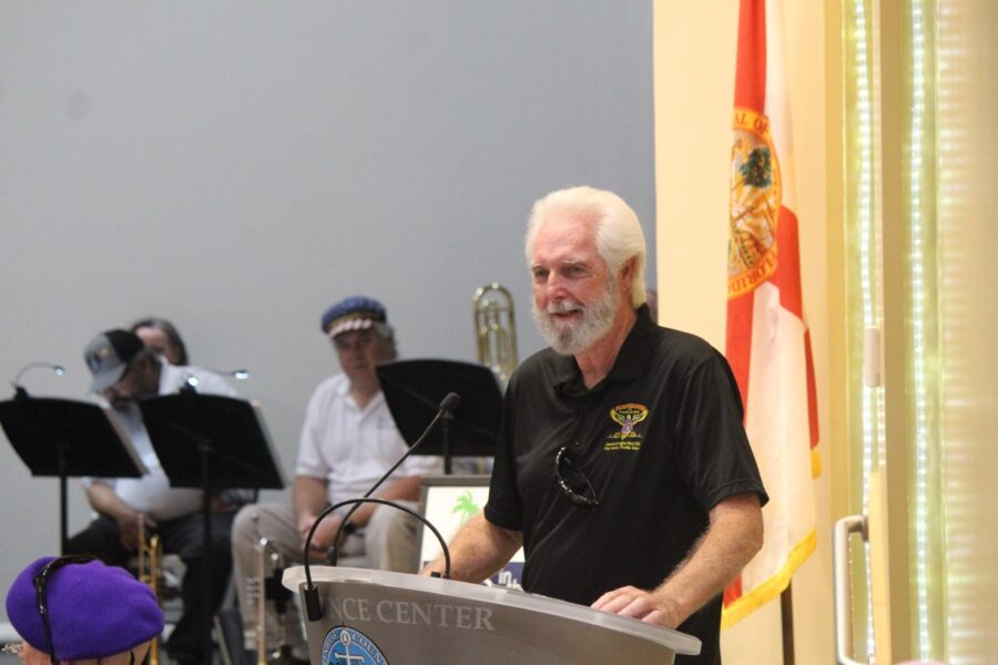 a man standing at a podium in front of a group of people