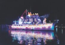 a large boat is lit up with christmas lights