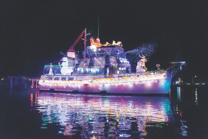 a large boat is lit up with christmas lights