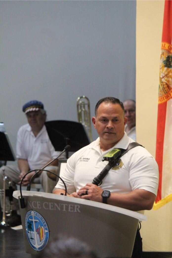 a man standing at a podium in front of a microphone