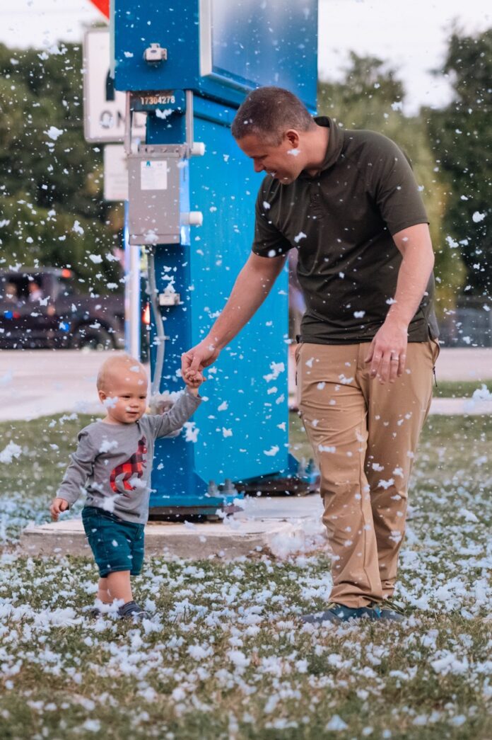 a man holding the hand of a small child