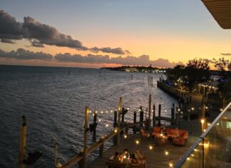 a restaurant with a view of the water at sunset