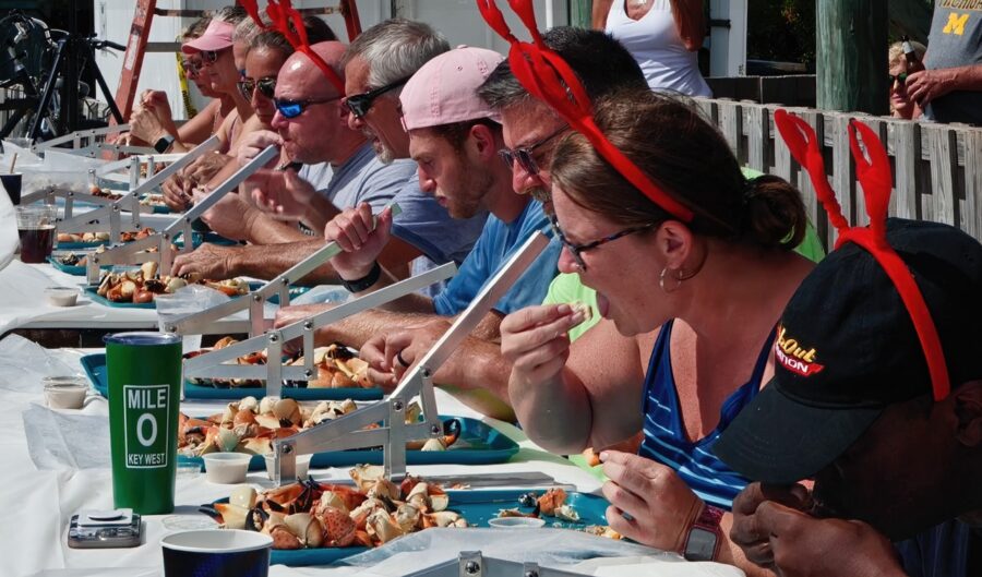 a group of people sitting at a table eating food