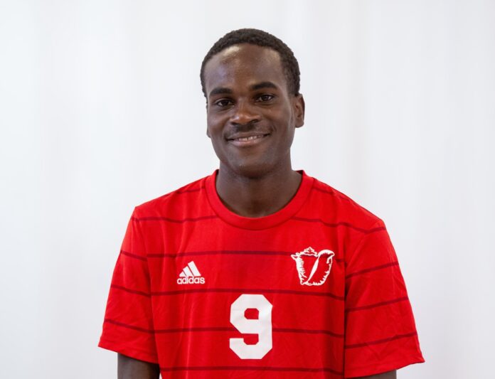 a man in a red shirt is posing for a picture