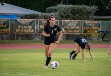 a group of young women playing a game of soccer