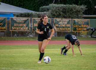 a group of young women playing a game of soccer