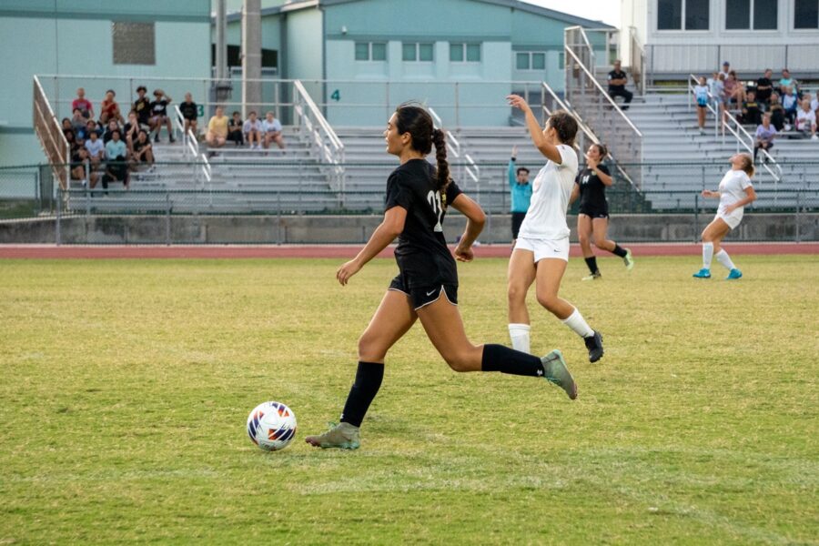 a group of girls playing a game of soccer