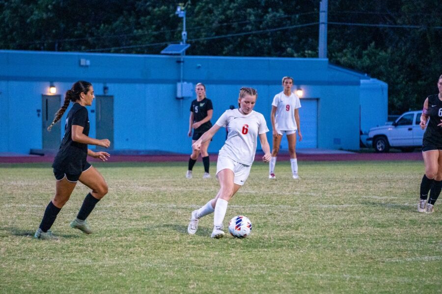 a group of young women playing a game of soccer