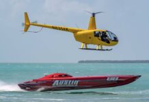 a helicopter flying over a boat in the ocean