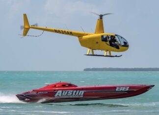 a helicopter flying over a boat in the ocean