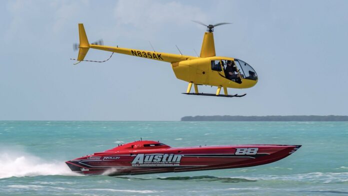 a helicopter flying over a boat in the ocean