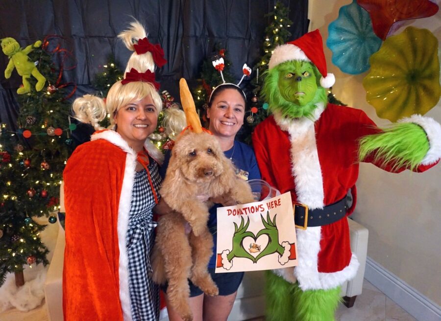 a couple of women standing next to a dog