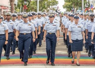 a group of women in uniform walking down a street