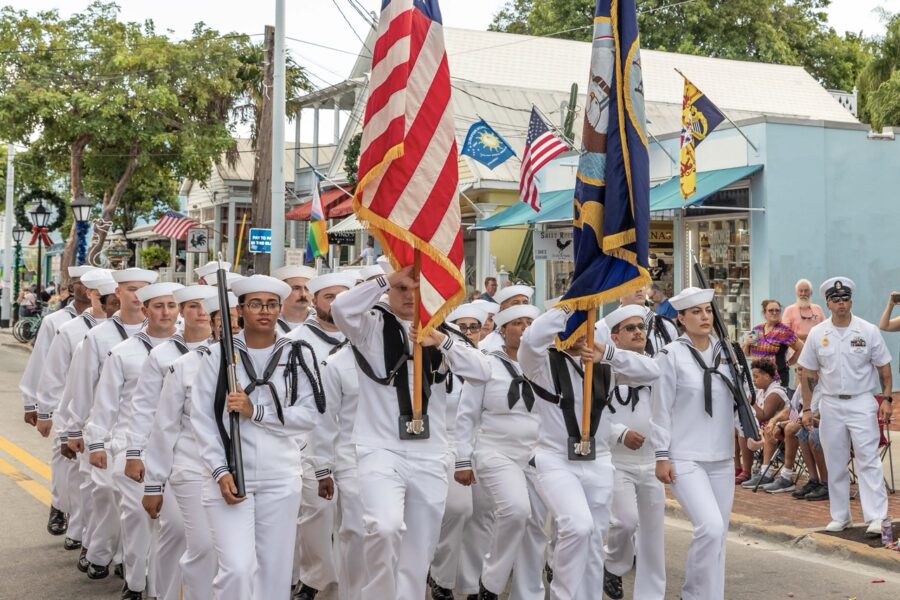 a group of sailors marching down a street