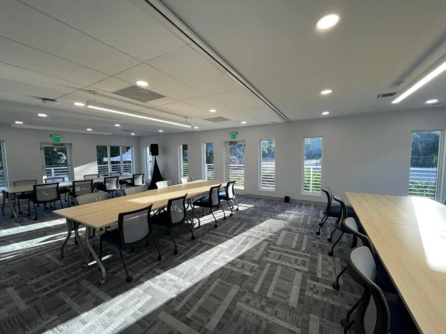 a large conference room with a long table and chairs