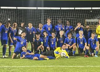 a soccer team posing for a team photo