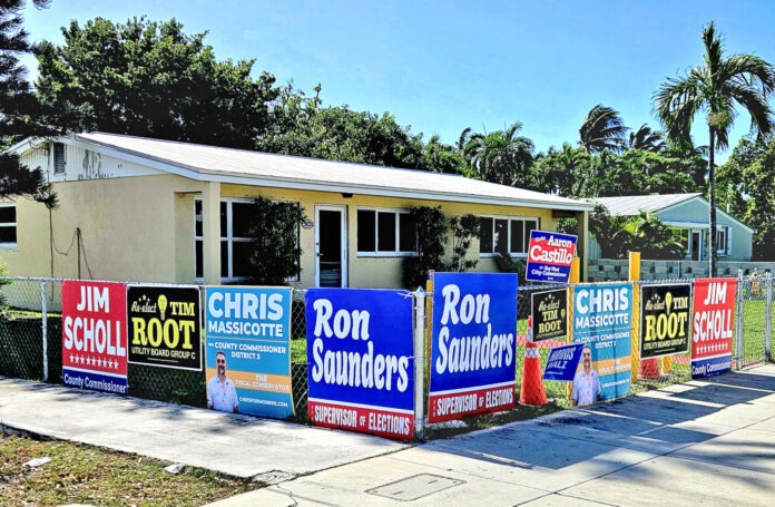 a row of houses with political signs on them