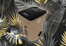 a trash can surrounded by tropical leaves