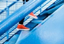 a person standing on a blue stair case