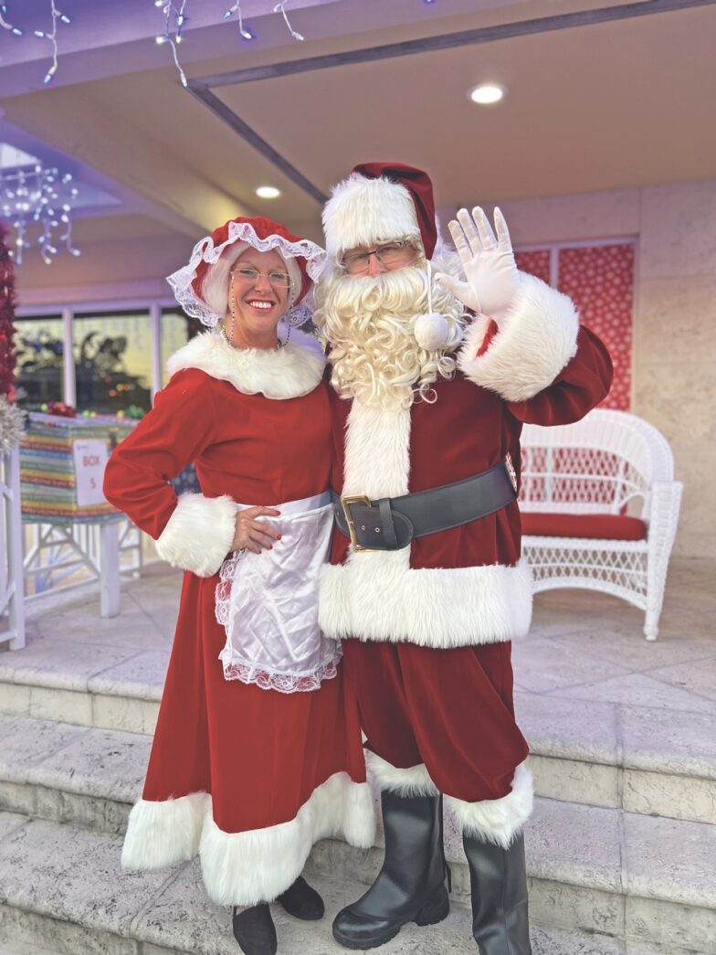 two people dressed as santa claus and mrs claus