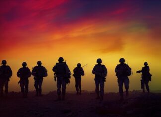 a group of soldiers standing on top of a hill