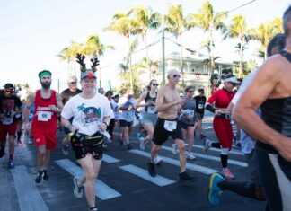 a group of people running down a street