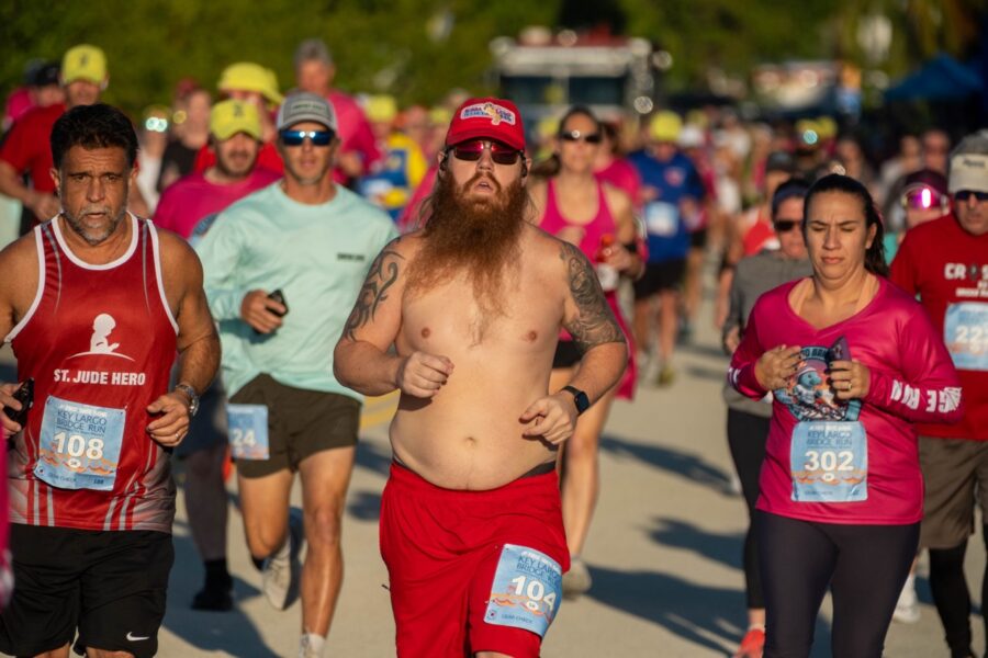 a man with a long beard running in a marathon