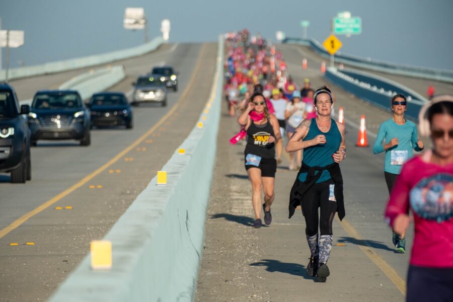 a group of people running down a road