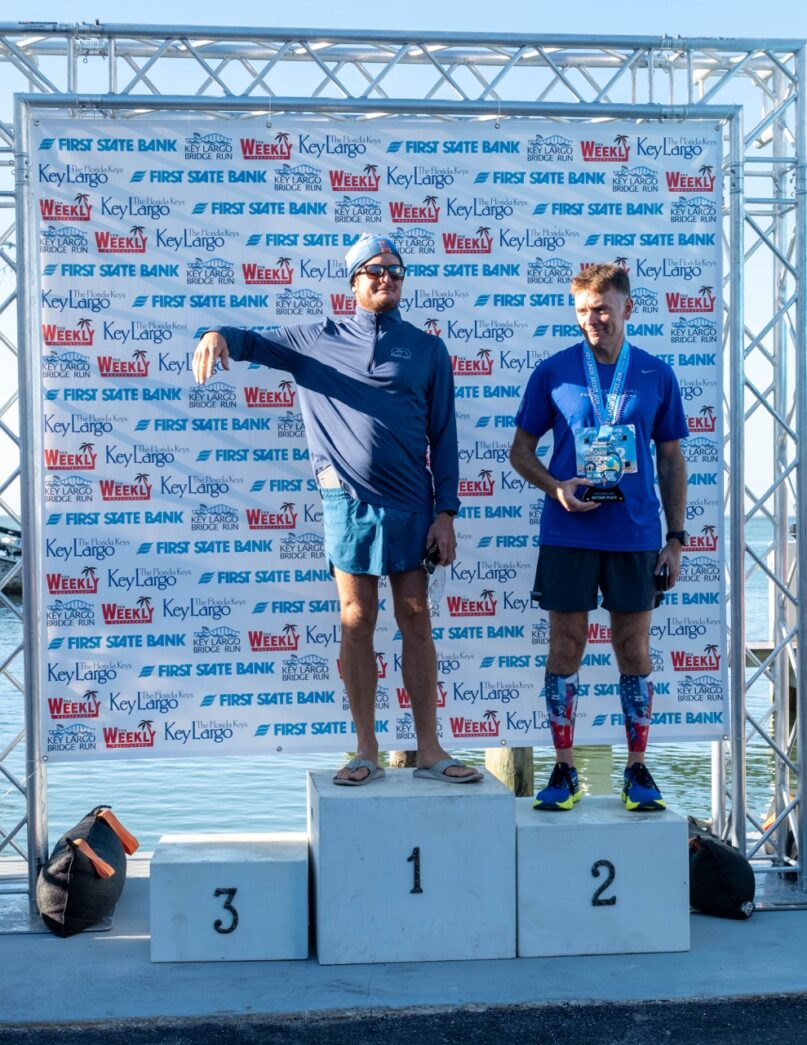 a couple of men standing on top of a podium