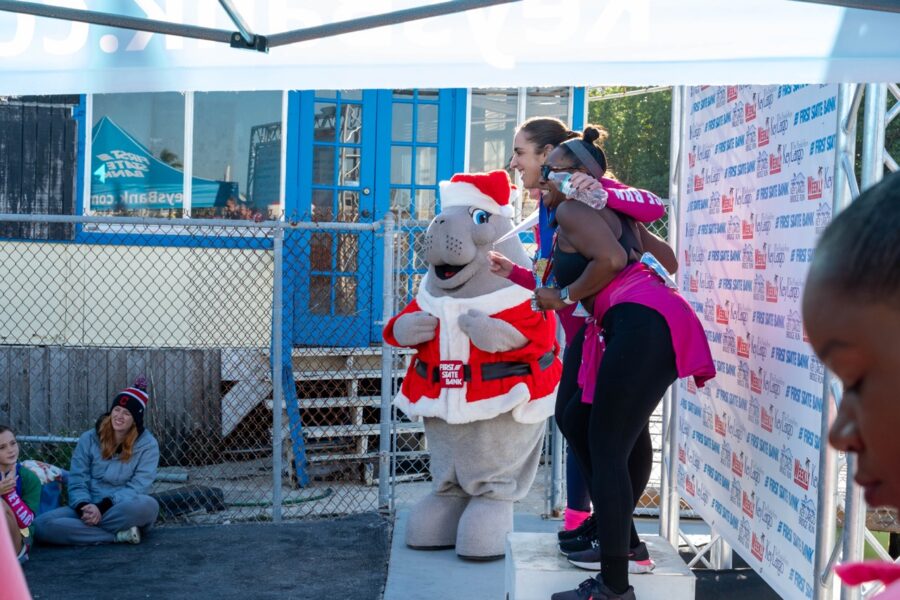 a group of people standing around a mascot