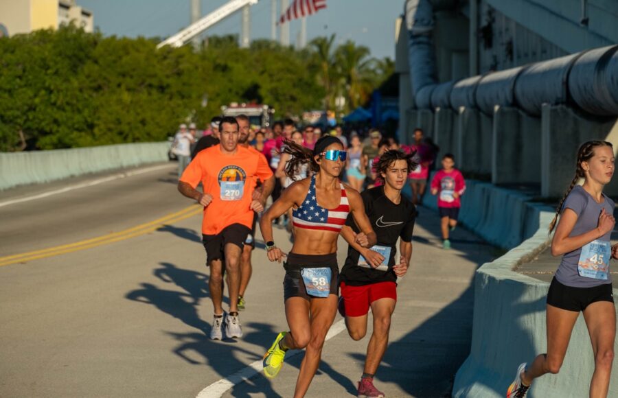 a group of people running on a bridge