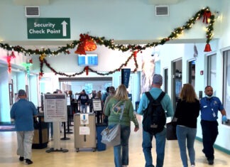 a group of people walking through an airport